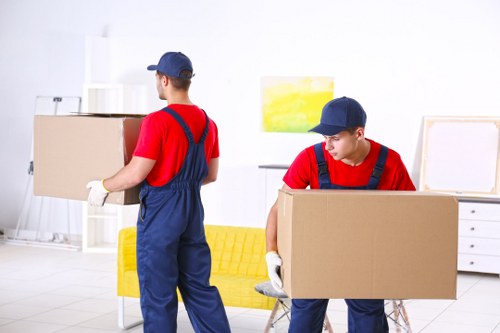 Local furniture pick-up team removing a sofa in Temple