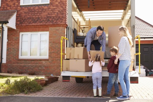 Movers carrying furniture carefully through a home entrance