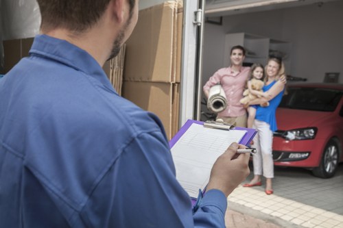 Furniture and boxes being loaded into a Temple removal van
