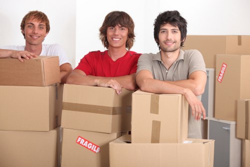 Residential movers carrying furniture in a Temple home