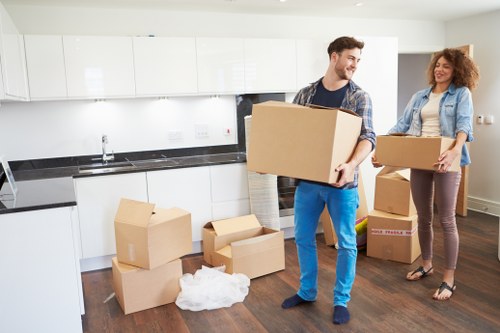 Removal crew unloading furniture into a new property in Temple