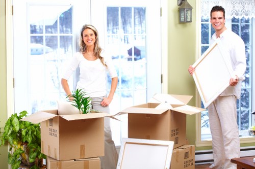 Moving crew handling desks and office supplies during a Temple office move