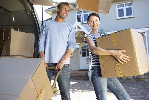 Movers carrying furniture through a residential property in Temple